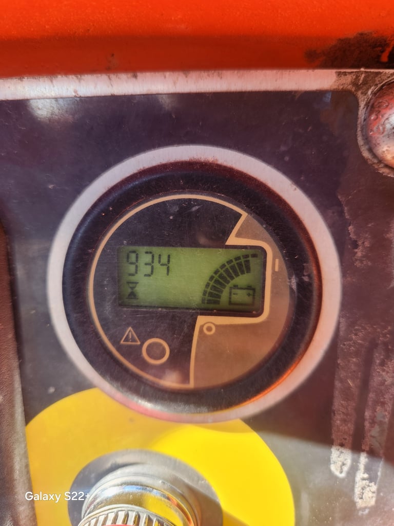 Digital gauge on machinery displaying 834 reading with yellow and copper colored indicator panel